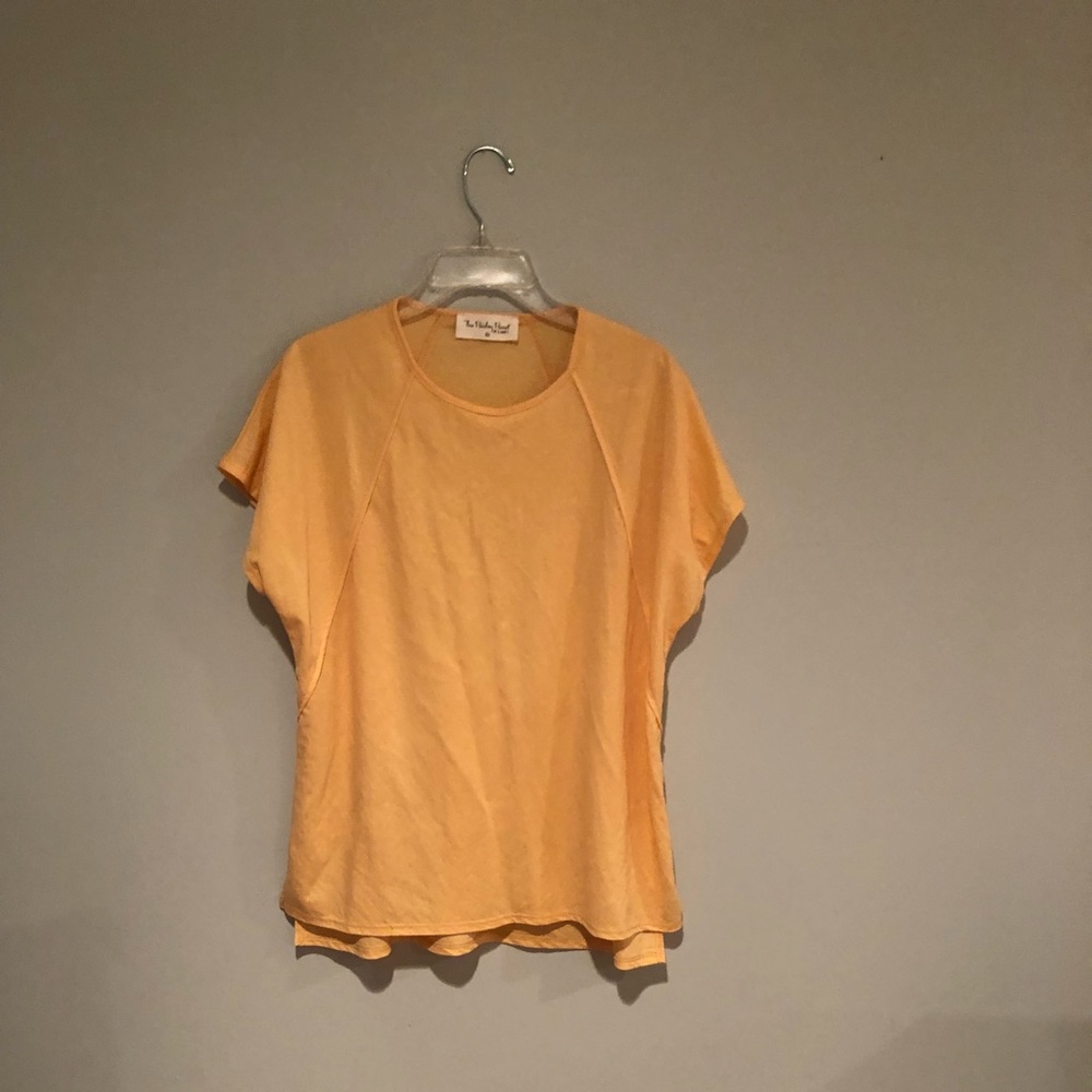 This top is a cantaloupe color. The brand is the Paisley parrot, size medium